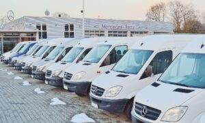 Line of dealer stock white commercial vans for commercial vehicle leasing