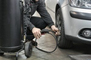 person filling tires with air for Seattle fleet management