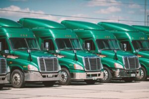 green trucks lined up for fleet management inspection