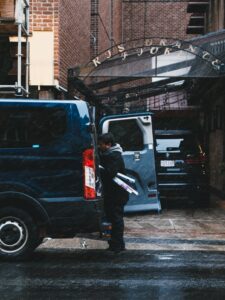 Electrician getting supplies out of van after Houston commercial vehicle leasing