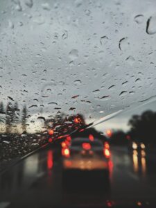 Rain on windshield to show why Houston fleet management for rainy conditions is essential. 