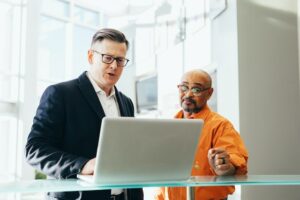 Two business men with laptop discussing fleet management