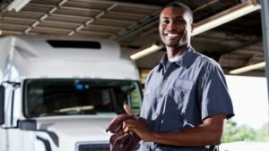 mechanic smiling after upfitting vehicle for Houston fleet management