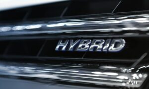 close-up of hybrid logo on commercial vehicle leasing car