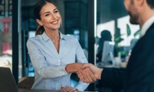 man and woman shaking hands to confirm Houston fleet leasing agreement