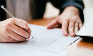 hands completing paperwork for fleet leasing